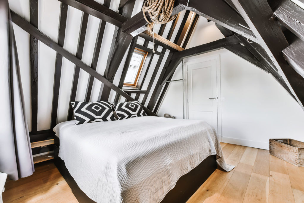 Stylish attic bedroom with a soft bed